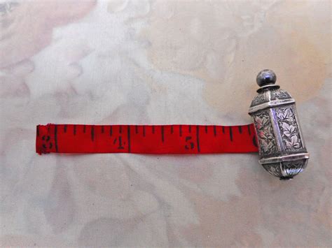 SOLD……An engraved silver tape measure. c 1860 – Curio Cabinet Antiques