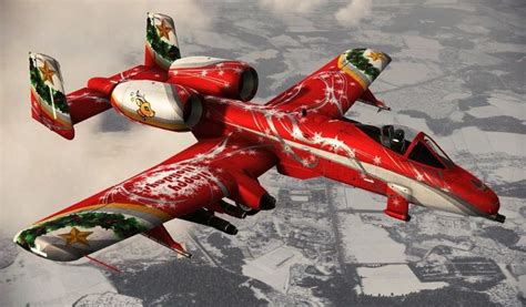 a red and white plane flying in the sky with christmas decorations on ...