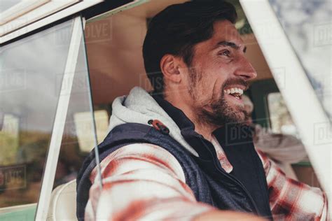 Man driving a van and smiling. Close up of happy caucasian man enjoying on a road trip. - Stock ...