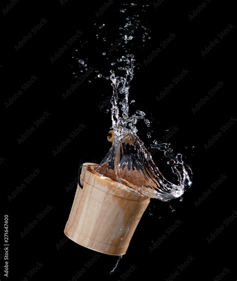 Wooden bucket with water splash or explosion flying in the air isolated ...