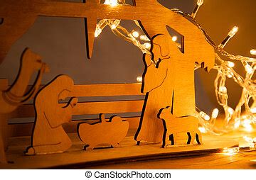 Christmas nativity scene of baby jesus in the manger with mary and joseph in silhouette ...