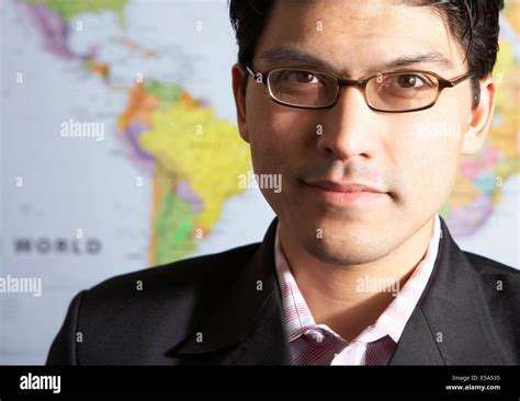 Mixed race businessman standing by world map Stock Photo - Alamy