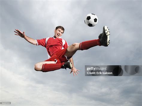 Soccer Player Kicking Soccer Ball In Midair High-Res Stock Photo - Getty Images