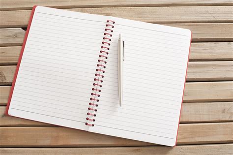 Free Image of Open Blank Notebook with Pen on Wooden Table | Freebie.Photography