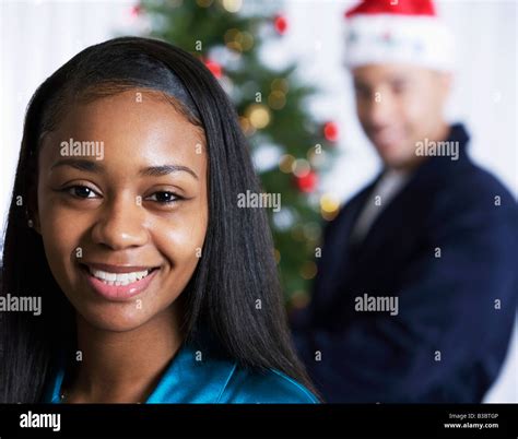 African woman in front of Christmas tree Stock Photo - Alamy