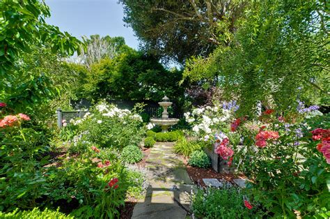 the garden is full of colorful flowers and trees