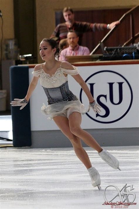 a female figure skating on an ice rink