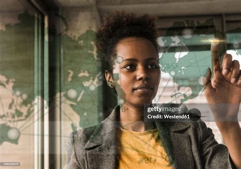 Young Woman Touching Glass Wall With World Map In Office High-Res Stock Photo - Getty Images