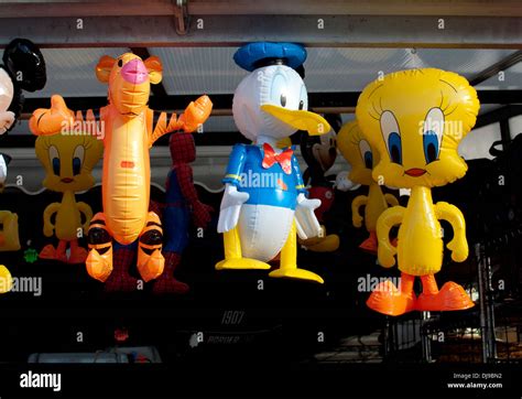 Inflatable cartoon characters on sale outside a shop Stock Photo - Alamy