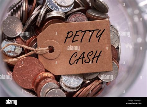 Petty cash label on British mixed coins inside a glass jar concept Stock Photo - Alamy