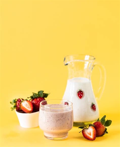 Premium Photo | Pink smoothie with banana and strawberry on a yellow background healthy diet and ...