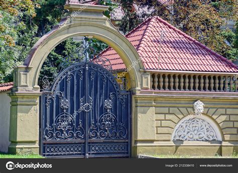 Large Black Iron Gate Forged Pattern Brown Concrete Fence Stock Photo ...