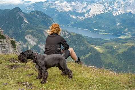 Hikers with Dog in the Austrian Alps Walk on Mountain Hiking Trails in the Woods Around the ...