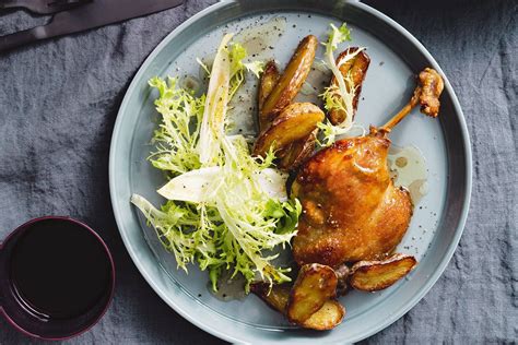 Duck confit with crispy potatoes and bitter leaf salad