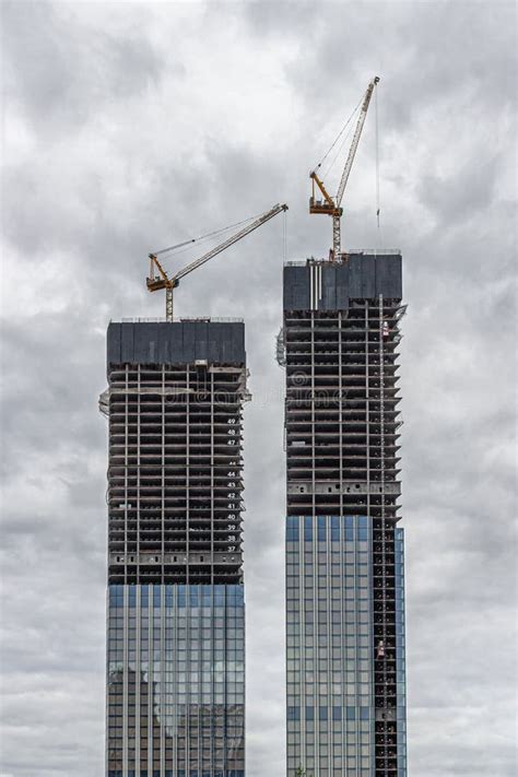 Two Skyscrapers Under Construction with Construction Cranes at the Top Stock Photo - Image of ...