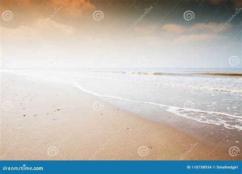 Sandy beach at sunset. stock photo. Image of scenery - 118758934