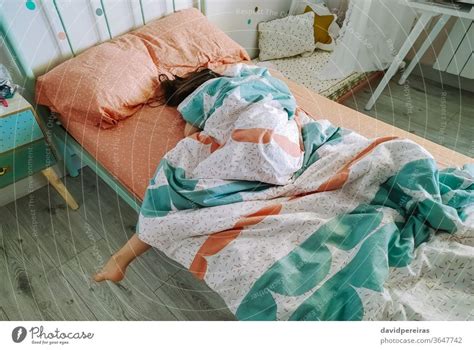 Girl sleeping covered up in her bed - a Royalty Free Stock Photo from ...