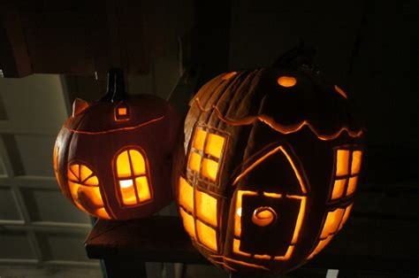 two carved pumpkins sitting on top of a table