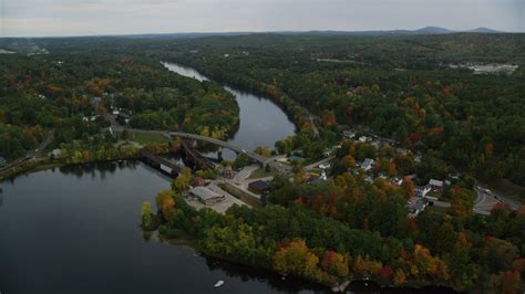 5.5K stock footage aerial video orbiting small town, small bridges, Merrimack River, autumn ...