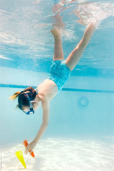 "Little Girl Diving Underwater In Cool Blue Swimming Pool" by Stocksy Contributor "JP Danko ...