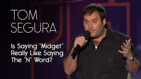 a man standing in front of a microphone with the words tom segura on it