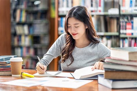 Asian young Student in casual suit reading and doing homework in ...