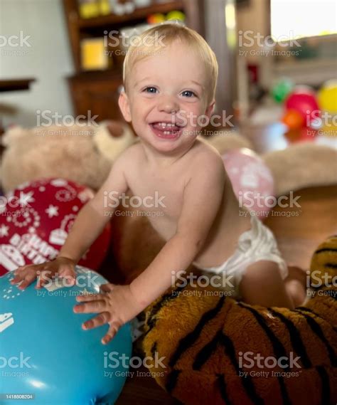 Happy Baby Boy Enjoying Birthday Balloons Stock Photo - Download Image Now - 12-17 Months, 12-23 ...