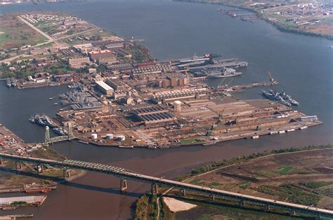 An overall high oblique aerial view of the Philadelphia Naval Shipyard looking east/southeast ...