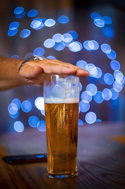 Premium Photo | Beer glass with hand and bokeh