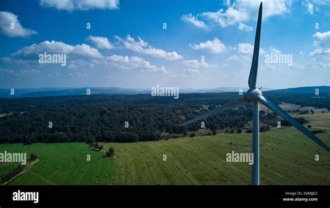 An aerial view of a wind turbine in a green field in the countryside Stock Photo - Alamy