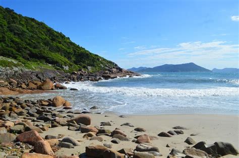 Premium Photo | Beach with sand and rocks