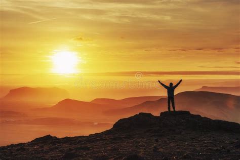 Happy Man Standing on a Cliff at Sunset Stock Photo - Image of backlit ...