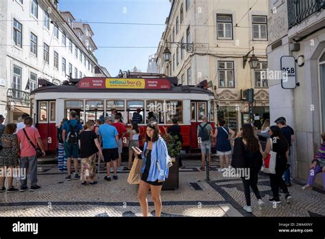 Tram crosses a pedestrian street, Alfama District, Lisbon, Portugal ...