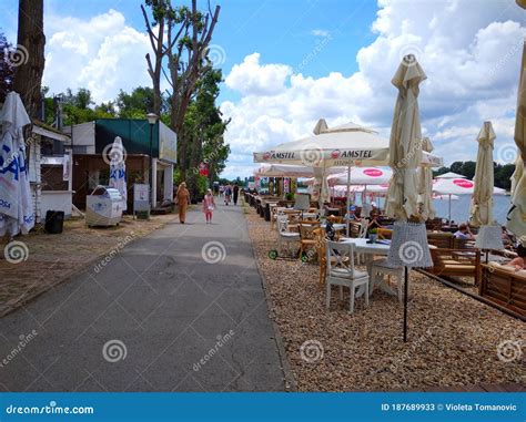 : People Relaxing on the Alleys with Restaurants of a Park Near Ada ...