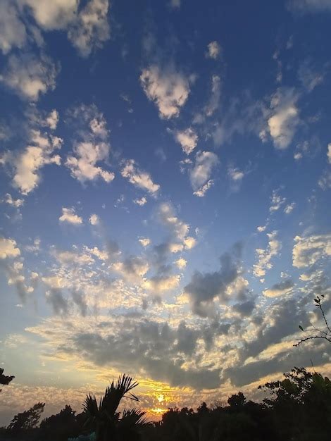 Premium Photo | A blue sky with clouds and a sunset in the background