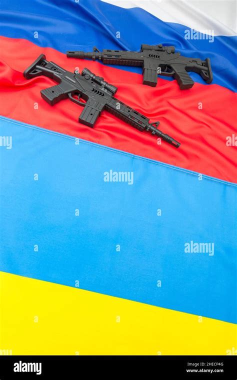 Russian & yellow blue Ukrainian flag + black painted toy assault rifle. For Ukraine-Russia ...