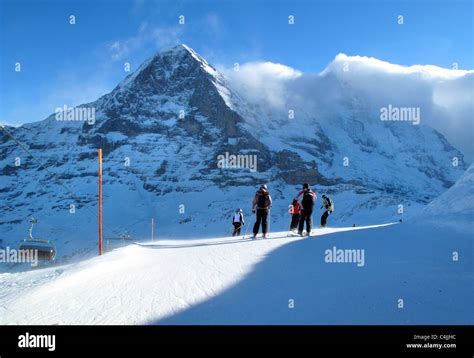 Skiers skiing towards the Eiger north face near Wengen, Switzerland Stock Photo - Alamy