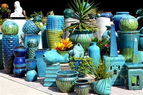 many different vases and planters on the ground