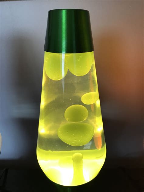 Premier lava lamp. Neon green wax and clear liquid on a metallic green ...