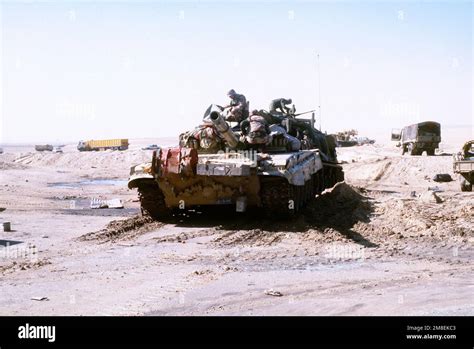 American servicemen check over an Iraqi T-72 main battle tank that was ...