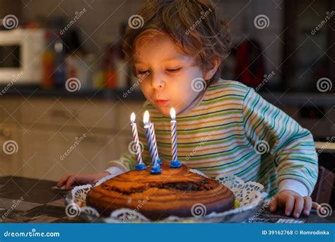 Adorable Four Year Old Boy Celebrating His Birthday and Blowing Stock ...