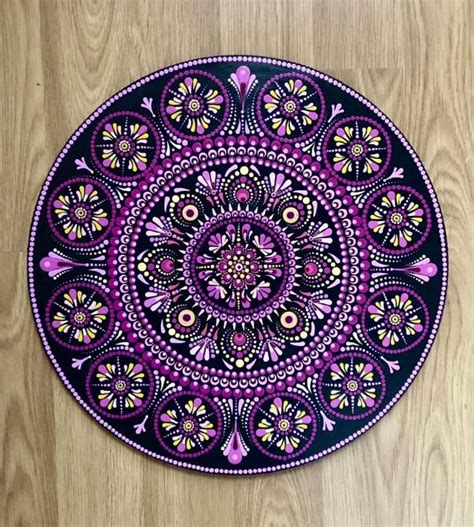 Purple and Black Mandala Art on Wooden Floor