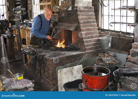 A Blacksmith Working Black Metal in a Historical 100 Year Old (smithy) Blacksmith Shop in Galena ...