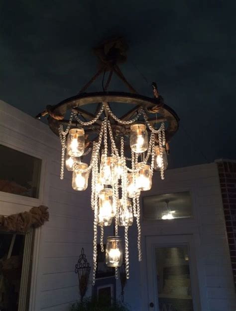 Wagon wheel chandelier with mason jars & strings of crystals. The most ...