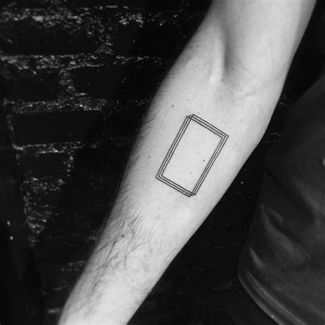 Minimalist geometric tattoo on the right inner forearm.