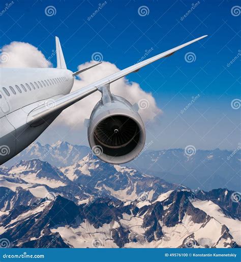 Plane Flying Over the Snow-capped Mountains. Stock Photo - Image of ...