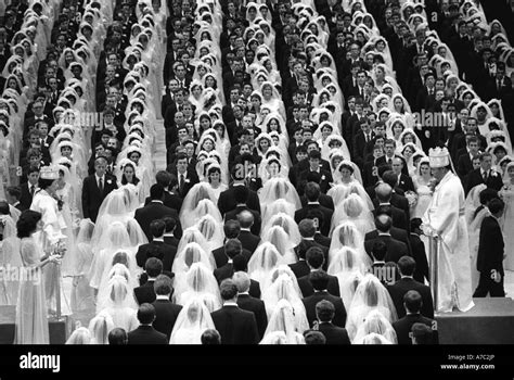 Rev Sun Myung Moon R and his wife L officiate over a mass wedding at Madison Square Garden in ...