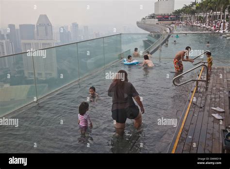 Guests relax at the Infinity Pool at the famous Marina Bay Sands Hotel ...