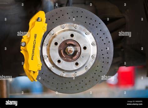 ceramic brake disc with yellow caliper mounted on the front axle of a ...