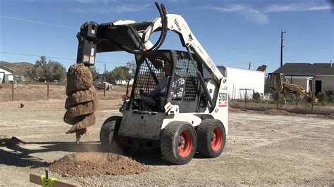 Digging holes With a Bobcat auger attachment - YouTube